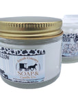 Jar of Amish Country Soap & Candle Co. product with gold lid on a white background