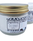 Jar of unscented candle with gold lid on a white background