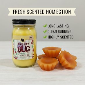 Jar of 'Bye Bye Bug' candle with wax melts on a light background